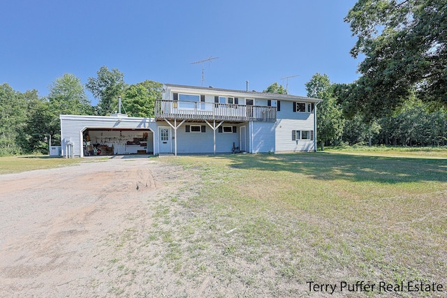 2860 Fenner Rd, Muskegon, MI 49445 - view of front of property featuring driveway, a front yard, a deck, and an attached carport