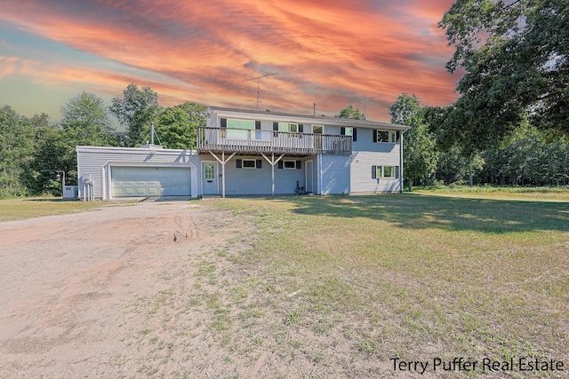 2860 Fenner Rd, Muskegon, MI 49445 - view of front facade featuring a yard, dirt driveway, a deck, and a garage