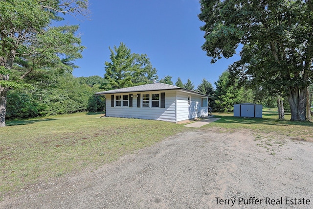 2860 Fenner Rd, Muskegon, MI 49445 - view of front facade with a storage unit and a front yard