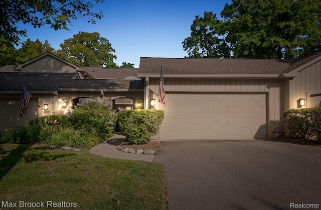1125 Meadowglen Ct, Bloomfield Hills, MI 48304 - view of front facade with an attached garage, asphalt driveway, a shingled roof, and board and batten siding
