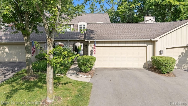 1125 Meadowglen Ct, Bloomfield Hills, MI 48304 - view of front of house featuring driveway, roof with shingles, a garage, and a chimney