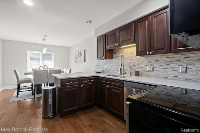 1125 Meadowglen Ct, Bloomfield Hills, MI 48304 - kitchen featuring range with electric stovetop, light countertops, dark wood-style flooring, a peninsula, and recessed lighting