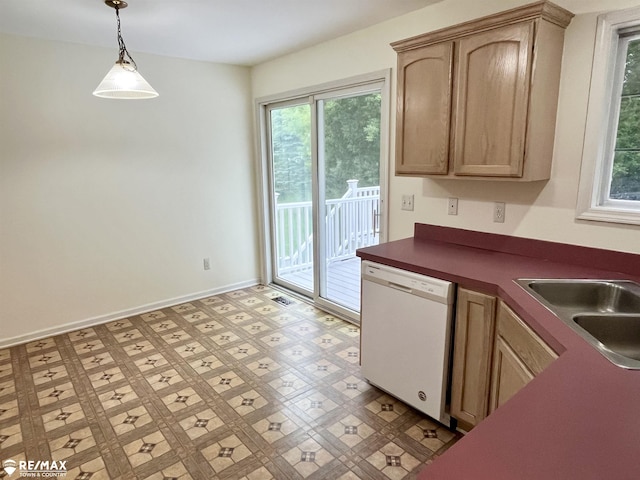 1421 Newcastle Dr, Davison, MI 48423 - kitchen featuring white dishwasher, healthy amount of natural light, dark countertops, and hanging light fixtures