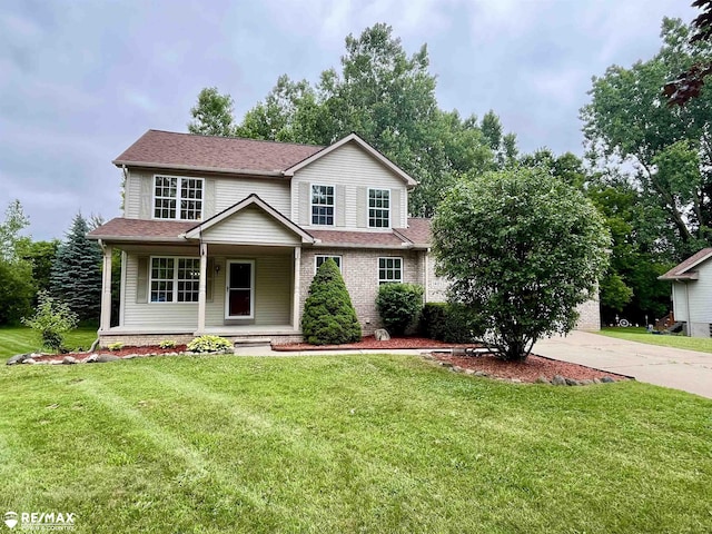 1421 Newcastle Dr, Davison, MI 48423 - view of front of house with a porch, a front yard, driveway, and a shingled roof
