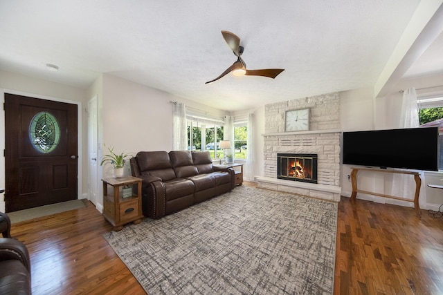 119 Burt Ave, Jackson, MI 49201 - living area featuring healthy amount of natural light, wood finished floors, ceiling fan, and a stone fireplace