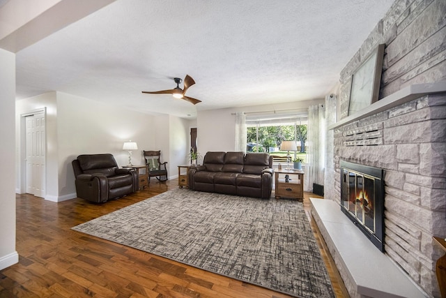 119 Burt Ave, Jackson, MI 49201 - living room featuring a stone fireplace, wood finished floors, ceiling fan, and a textured ceiling