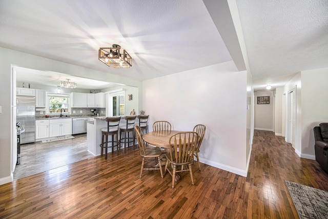 119 Burt Ave, Jackson, MI 49201 - dining area with dark wood finished floors and a chandelier