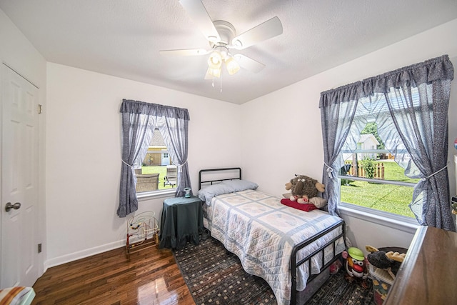 119 Burt Ave, Jackson, MI 49201 - bedroom with wood finished floors, multiple windows, and a ceiling fan
