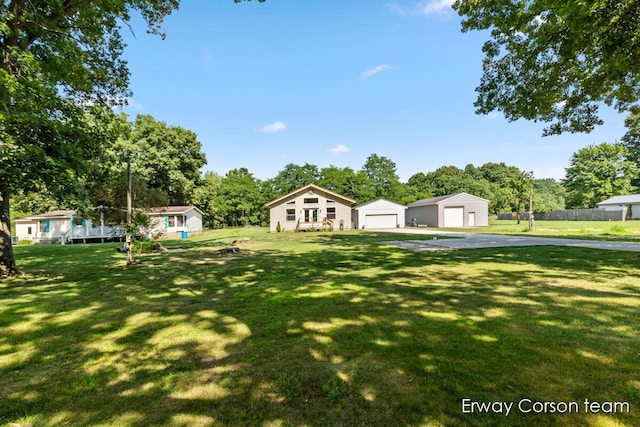 5599 Marsh Rd, Shelbyville, MI 49344 - view of yard with a garage, an outbuilding, and view of wooded area