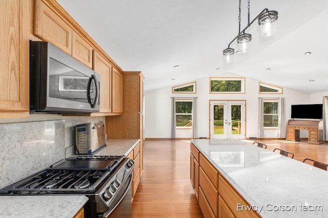 5599 Marsh Rd, Shelbyville, MI 49344 - kitchen featuring gas stove, open floor plan, wood finished floors, tasteful backsplash, and lofted ceiling