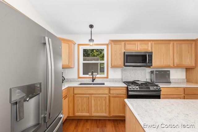 5599 Marsh Rd, Shelbyville, MI 49344 - kitchen featuring stainless steel appliances, light countertops, wood finished floors, decorative light fixtures, and light brown cabinets