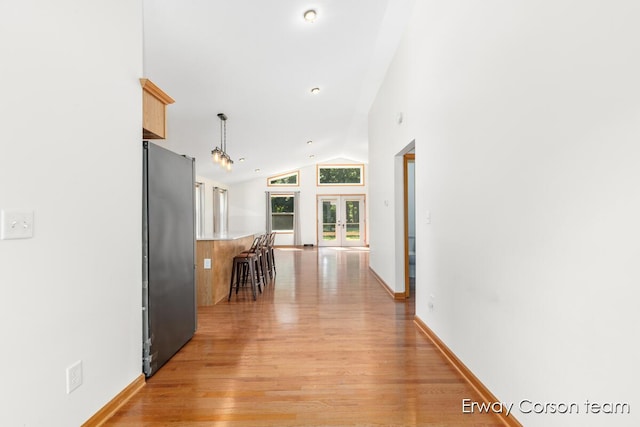 5599 Marsh Rd, Shelbyville, MI 49344 - hall with french doors, light wood-style flooring, and vaulted ceiling
