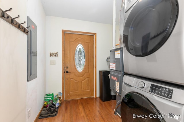 5599 Marsh Rd, Shelbyville, MI 49344 - laundry area featuring estacked washer and dryer and wood finished floors