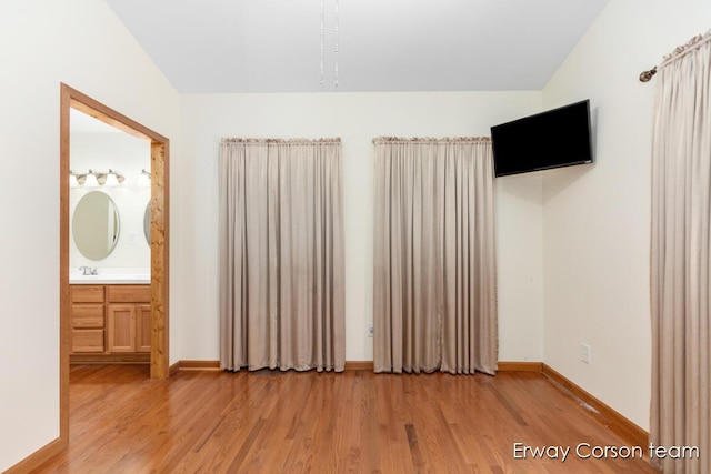5599 Marsh Rd, Shelbyville, MI 49344 - unfurnished bedroom with light wood-style flooring and ensuite bathroom