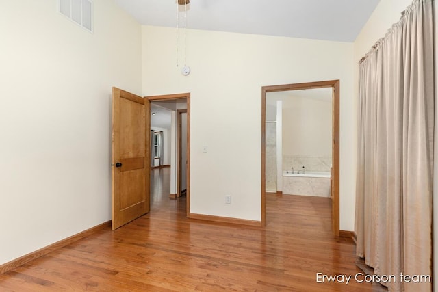 5599 Marsh Rd, Shelbyville, MI 49344 - unfurnished bedroom featuring light wood-style flooring and lofted ceiling