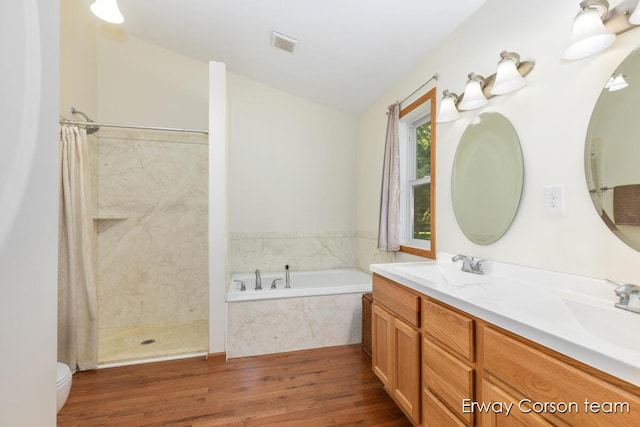 5599 Marsh Rd, Shelbyville, MI 49344 - bathroom featuring a bath, a shower with shower curtain, wood finished floors, and double vanity