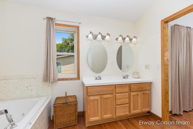 5599 Marsh Rd, Shelbyville, MI 49344 - full bathroom featuring double vanity, wood finished floors, and a jetted tub