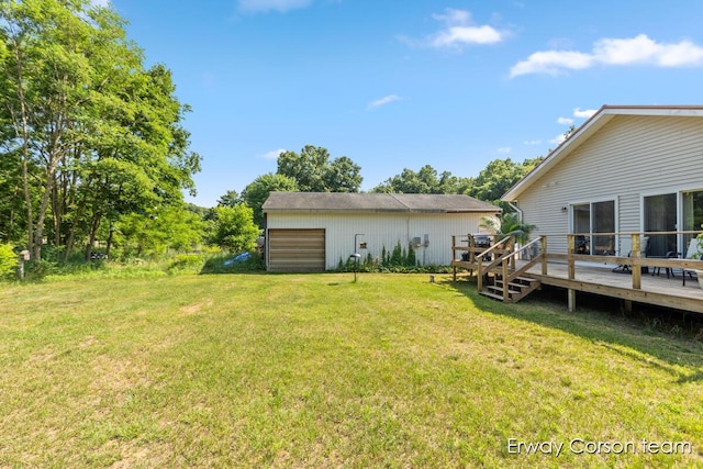 5599 Marsh Rd, Shelbyville, MI 49344 - view of grassy yard with a deck, an outbuilding, and a garage