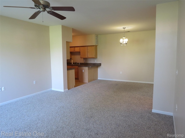 3153 Kneeland Cir, Howell, MI 48843 - unfurnished living room with light carpet, a chandelier, and a ceiling fan