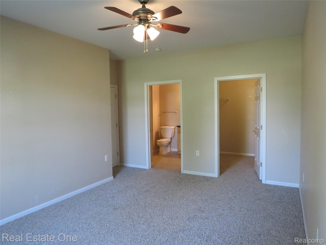 3153 Kneeland Cir, Howell, MI 48843 - unfurnished bedroom with a spacious closet, carpet floors, connected bathroom, and ceiling fan