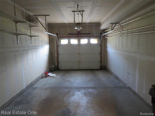 3153 Kneeland Cir, Howell, MI 48843 - garage featuring a garage door opener and baseboards