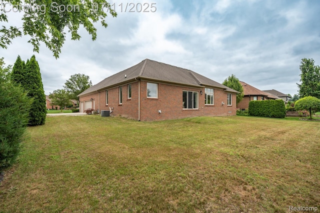 13823 Blue Beech Ln, Shelby Twp, MI 48315 - rear view of property featuring brick siding, a yard, an attached garage, and a shingled roof