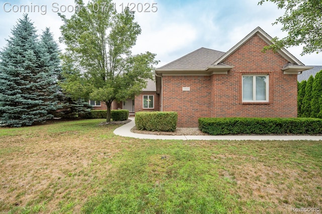 13823 Blue Beech Ln, Shelby Twp, MI 48315 - view of side of home with brick siding and a lawn