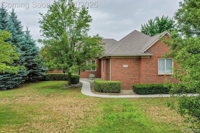 13823 Blue Beech Ln, Shelby Twp, MI 48315 - view of property exterior with a yard, brick siding, and roof with shingles