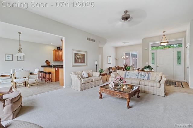 13823 Blue Beech Ln, Shelby Twp, MI 48315 - living room with light tile patterned floors, light carpet, a chandelier, and ceiling fan