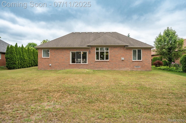 13823 Blue Beech Ln, Shelby Twp, MI 48315 - back of house with brick siding, a yard, and roof with shingles