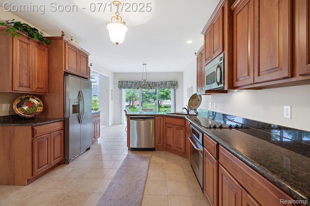 13823 Blue Beech Ln, Shelby Twp, MI 48315 - kitchen featuring appliances with stainless steel finishes, brown cabinetry, a peninsula, hanging light fixtures, and recessed lighting