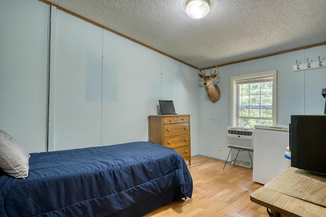 13113 Pinewood St NE, Gowen, MI 49326 - bedroom with light wood-style flooring and a textured ceiling