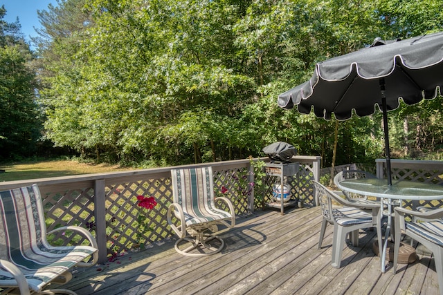 13113 Pinewood St NE, Gowen, MI 49326 - deck featuring outdoor dining area and view of scattered trees