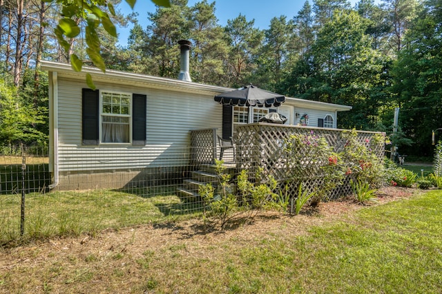13113 Pinewood St NE, Gowen, MI 49326 - rear view of house with a wooden deck