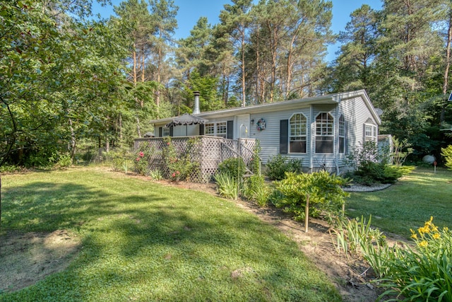 13113 Pinewood St NE, Gowen, MI 49326 - view of front of home featuring a front yard and a deck