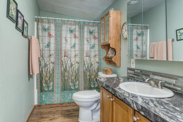 13113 Pinewood St NE, Gowen, MI 49326 - full bathroom featuring vanity, wood finished floors, a textured ceiling, and a shower with shower curtain