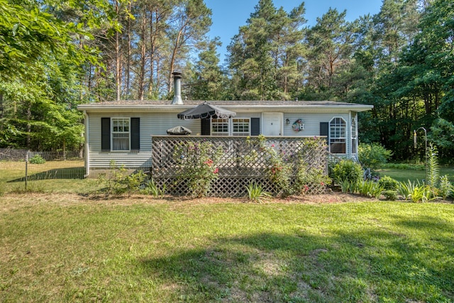 13113 Pinewood St NE, Gowen, MI 49326 - view of front of home featuring a wooden deck and view of scattered trees