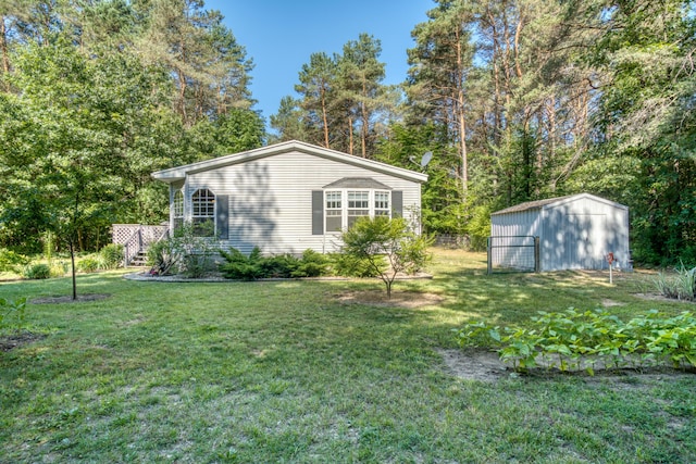 13113 Pinewood St NE, Gowen, MI 49326 - view of side of home featuring a lawn and an outbuilding