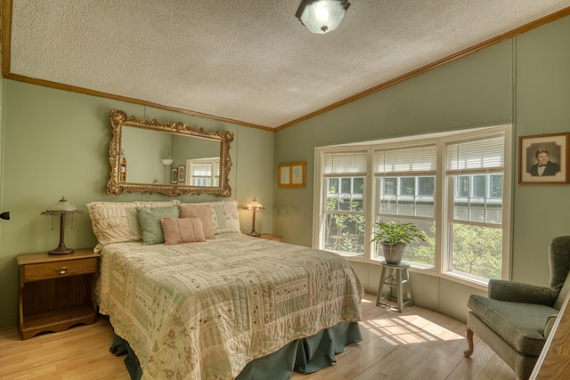 13113 Pinewood St NE, Gowen, MI 49326 - bedroom featuring vaulted ceiling, a textured ceiling, wood finished floors, and ornamental molding