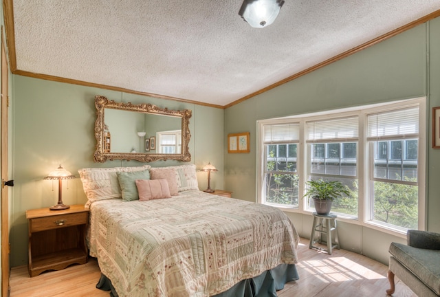 13113 Pinewood St NE, Gowen, MI 49326 - bedroom with lofted ceiling, wood finished floors, a textured ceiling, and crown molding