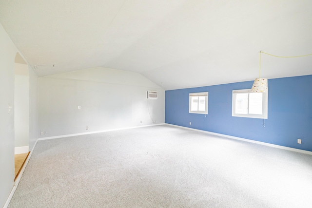 8876 Sheldon Rd, Plymouth, MI 48170 - additional living space with a wall mounted air conditioner, carpet floors, and vaulted ceiling