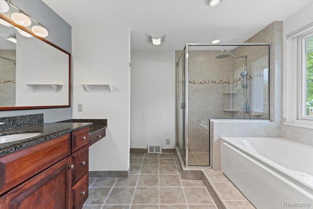 12360 Moers Dr, Sterling Heights, MI 48313 - bathroom with vanity, a garden tub, a stall shower, tile patterned flooring, and recessed lighting