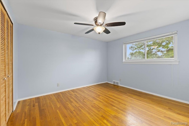 12360 Moers Dr, Sterling Heights, MI 48313 - unfurnished bedroom with a closet, wood finished floors, and ceiling fan