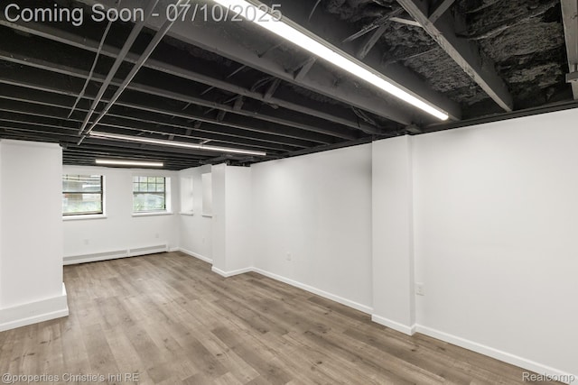 120 Seward St Unit U2, Detroit, MI 48202 - basement with a baseboard heating unit and wood finished floors