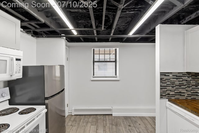 120 Seward St Unit U2, Detroit, MI 48202 - kitchen with a baseboard heating unit, white appliances, white cabinets, light wood finished floors, and decorative backsplash