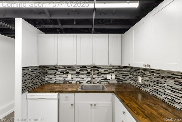 120 Seward St Unit U2, Detroit, MI 48202 - kitchen featuring butcher block counters, dishwasher, backsplash, and white cabinetry