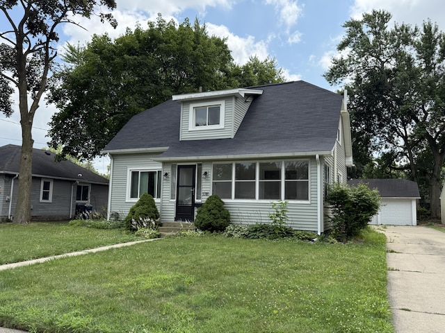 1316 Vassar Dr, Kalamazoo, MI 49001 - view of front of home with a front yard, a detached garage, and roof with shingles
