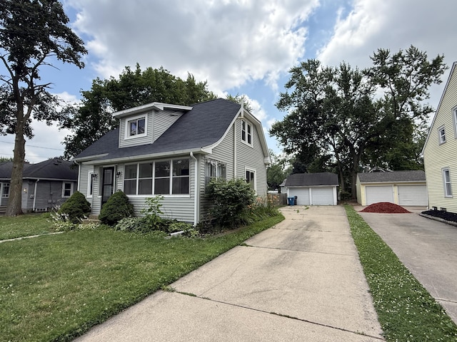 1316 Vassar Dr, Kalamazoo, MI 49001 - view of front of house with a detached garage, a front lawn, and an outdoor structure