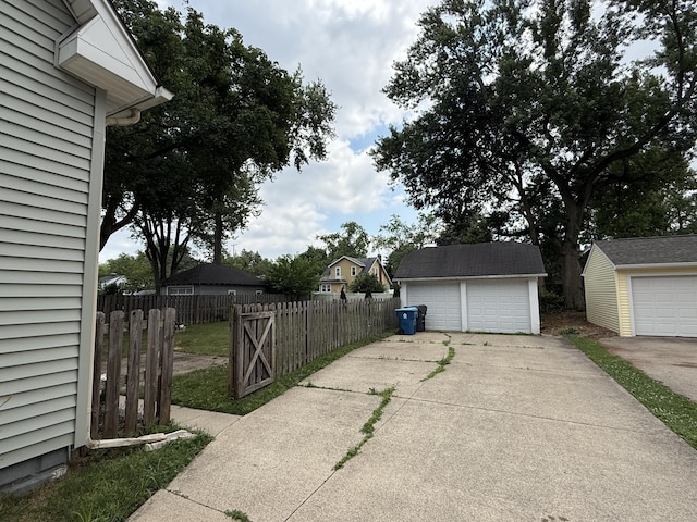 1316 Vassar Dr, Kalamazoo, MI 49001 - view of property exterior with an outdoor structure and a garage