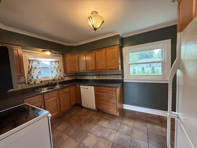 1316 Vassar Dr, Kalamazoo, MI 49001 - kitchen featuring white appliances, healthy amount of natural light, tasteful backsplash, dark countertops, and ornamental molding